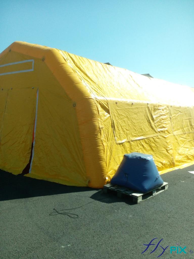 Porte d'accès principale de la tente médicale gonflable et sac de lestage à remplir de sable pour les haubans.